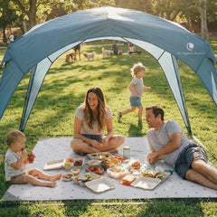 Family enjoying a picnic under the Pop 'N Go Canopy, showcasing outdoor shade and comfort.