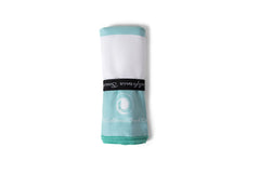 The Coastline Beach Towel rolled up in aqua and white, showcasing its soft and absorbent fabric, perfect for summer.