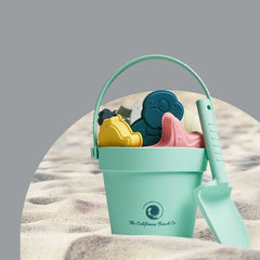 Sea Creatures Beach Toy Set in a mint green bucket with colorful ocean-themed toys and a shovel for fun sand play.