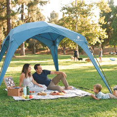 Family enjoying a picnic under the Pop 'N Go Canopy, showcasing outdoor shade and comfort.