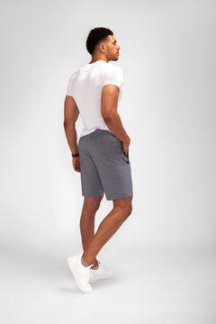 Model wearing Urban Stride All-Day Wear Shorts from behind, showcasing tall fit, comfort, and modern streetwear style.